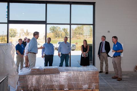 group of people touring construction of the Grain and Forage Center of Excellence at the University of Kentucky Research and Education Center at Princeton.