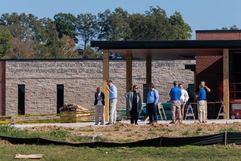 group of people touring construction of the Grain and Forage Center of Excellence at the University of Kentucky Research and Education Center at Princeton.