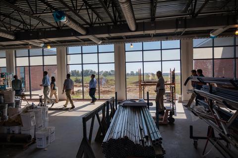 group of people touring construction of the Grain and Forage Center of Excellence at the University of Kentucky Research and Education Center at Princeton.